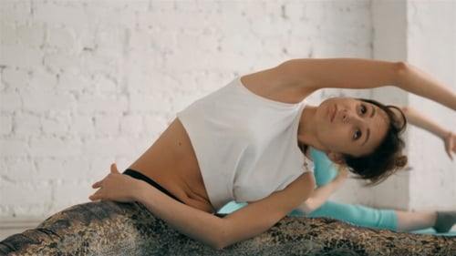 Young Women Stretching in Yoga Class Indoors