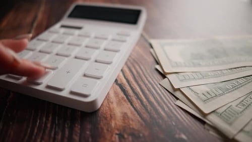 A Woman is Calculating Her Expenses for a Month