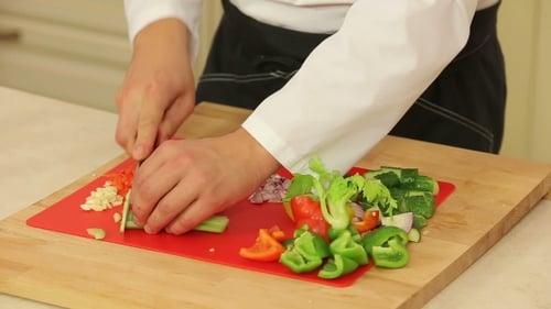 Chef Cutting Fresh Vegetables on Cutting Board