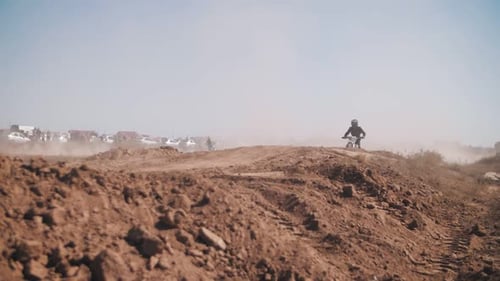 Motorcycle Rider Performing Jump in Desert Landscape