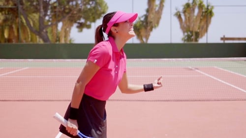 Woman Celebrates Victory on Tennis Court