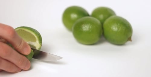 Cutting a Lime on a White Background