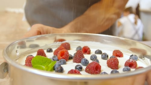 Decorating Cake with Fresh Berries and Powdered Sugar