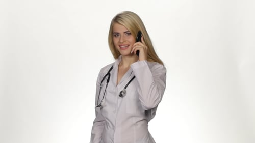 Female Doctor Talking on Phone Against White Background