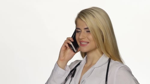 Happy Woman Doctor Talking on Cell Phone