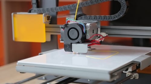 3D Printer Creating Object in Workplace Setting