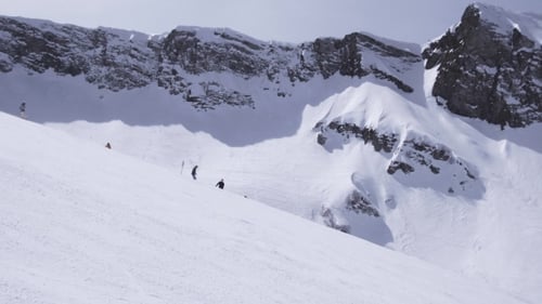 Landscape Of Snowy Mountains In Sunny Day. Ski Resort. Snowboarders On Slope.