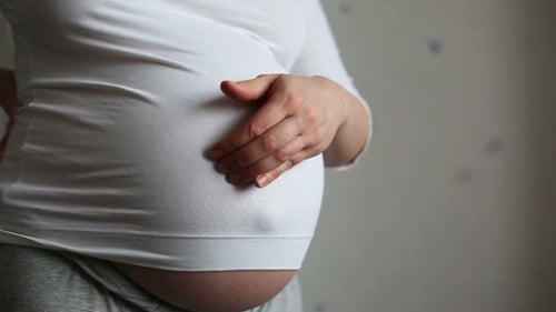 Pregnant Woman Gently Touching Belly