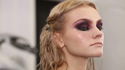 Professional Makeup Artist Putting Cosmetics On Model Face