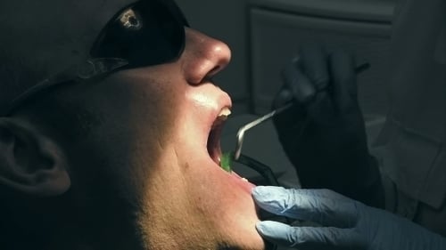 Man Receiving Dental Exam at the Dentist Office