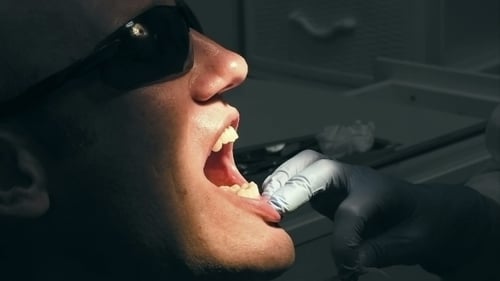 Man Receiving Dental Exam at Dentist's Office