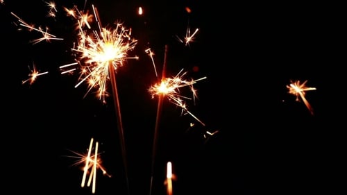 Three Golden Sparklers Burning in the Dark