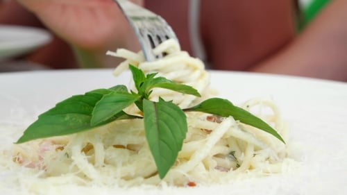 Close Up of Woman Eating Delicious Pasta Dish