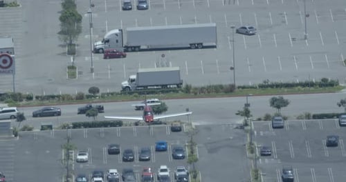 Helicopter aerial of mountain, panning to reveal body of water in the background, foggy day