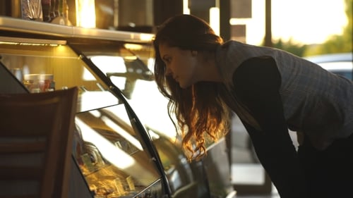 Woman Looks at Pastries in Display Case