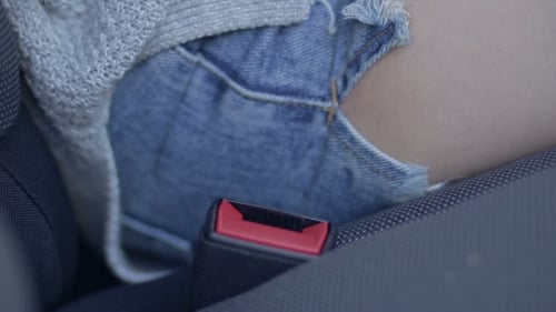 Of Female Fastening Safety Belt In Car