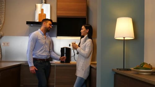 Couple Conversing in Modern Kitchen over Coffee