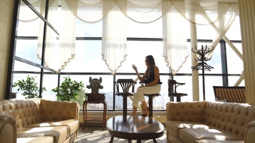 Fashionable Woman Using Phone in Modern Apartment