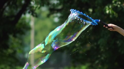 Enchanting Iridescent Soap Bubbles Floating in the Sunlight