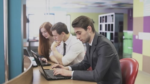 Man Working On Laptop In Office