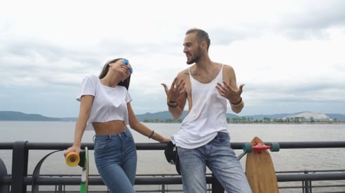 Friends Talking near Skateboards in a City Environment