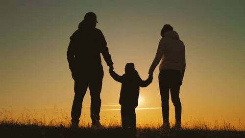 Silhouette Family Holding Hands at Sunset