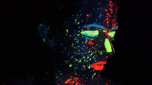 Portrait of a Girl in the Neon Light. Face Painted with Glow in the Dark Paint