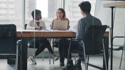 Multiracial Business Group Team Partners Coworkers Paperwork in Office with Laptop Documents Papers