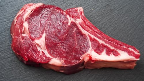 Meat Rotating Background. Raw Beef Entrecote Close Up Video Backdrop. Food Concept