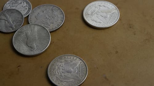 Antique Silver Coins on Flat Surface