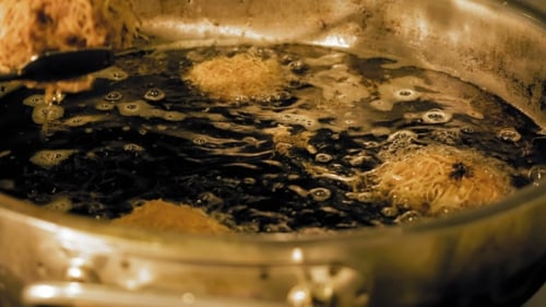 Round Dough In a Hot Pan With Boiling Cooking Oil