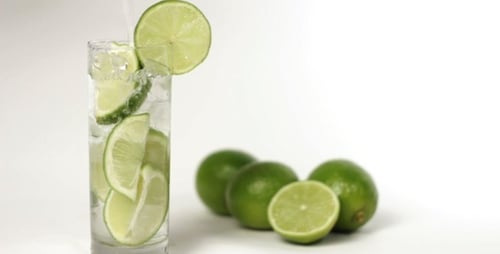 Refreshing Lime Drink with Slices of Fruit
