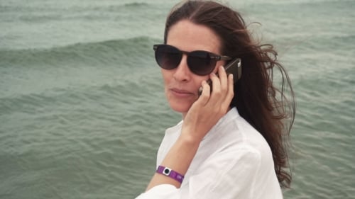Woman Talking on Cell Phone Near the Ocean