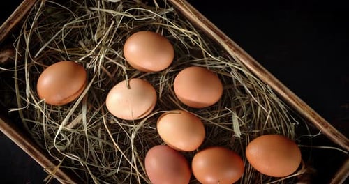 Brown Eggs Nestled in Straw-Filled Wooden Crate