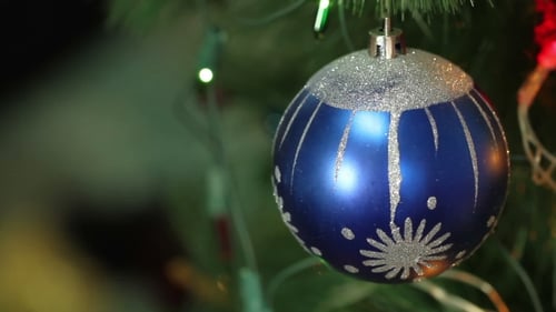 Festive Blue Glitter Ornament Hanging on Christmas Tree