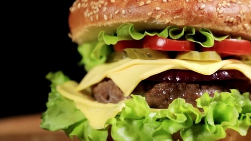 Close Up View of Delicious Cheeseburger with Toppings