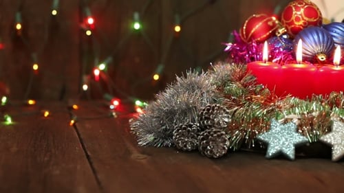 Festive Christmas Ornaments and Candles on Wood Surface
