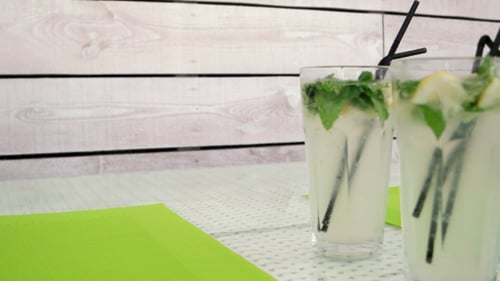 Refreshing Drinks with Mint and Lemon on Table