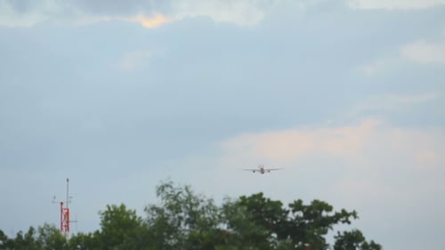 Airplane Flies in Blue Cloudy Sky After Takeoff