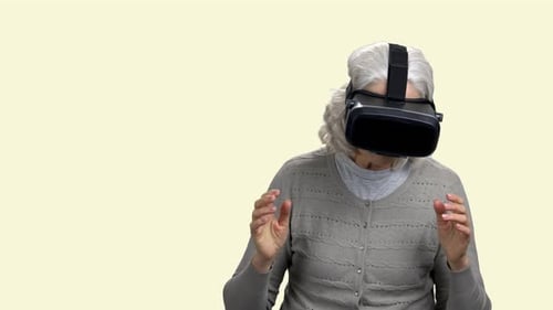 Mature Woman Wearing Virtual Reality Goggles