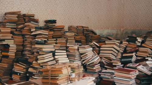 Stack Of Books Scattered On The Floor In The Library