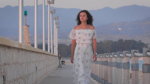 A Beautiful Romantic Sad Woman Walking At a Port