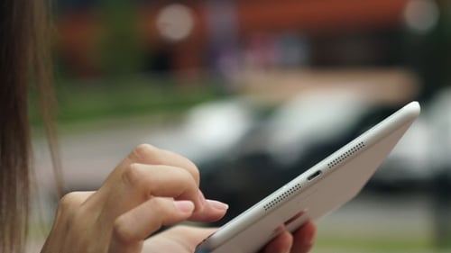 Woman Using Tablet Computer in Urban Setting