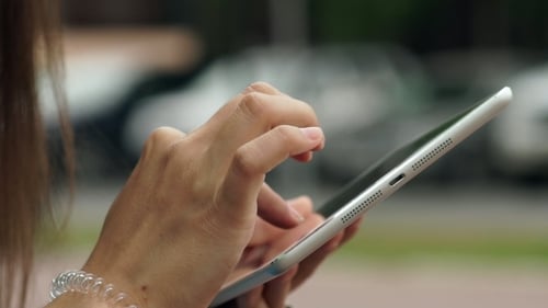 Woman Using Tablet Device in Urban Environment