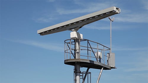 Rotating Ship Radar Antenna Against a Blue Sky