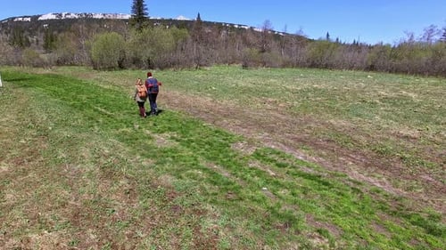 Couple Walking on Green Grass on Hike