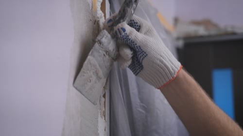 Hand Smoothing Plaster on Door Frame Edge