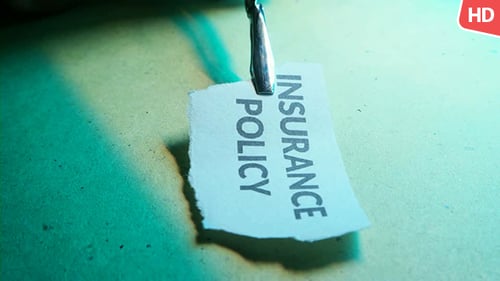 Insurance Policy Concept Held in Tweezers Macro Shot