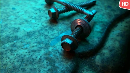 Macro Shot of Silver Screws on Blue Surface