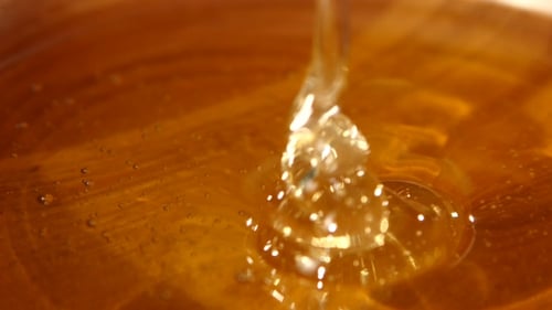 Taking Honey By Using Metal Spoon In Wooden Bowl, Flowing Down,